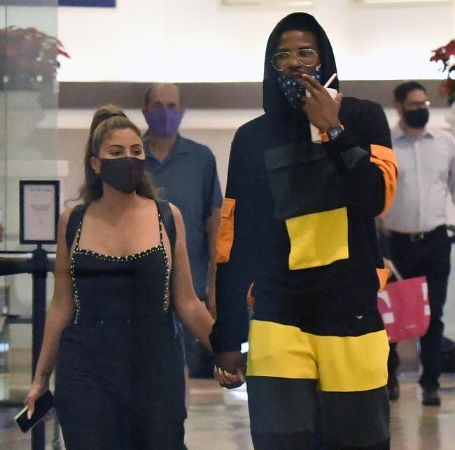 Larsa Pippen and Malik Beasley together holding hands.